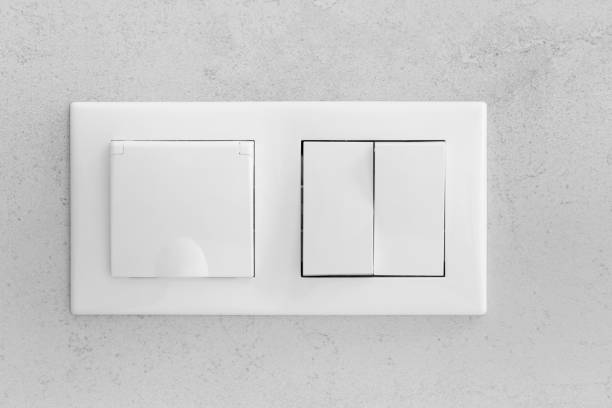 istock Closed socket and switch on the wall in the bathroom 1572792229