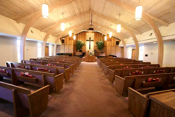 Sanctuary of a small church with pews and pulpit