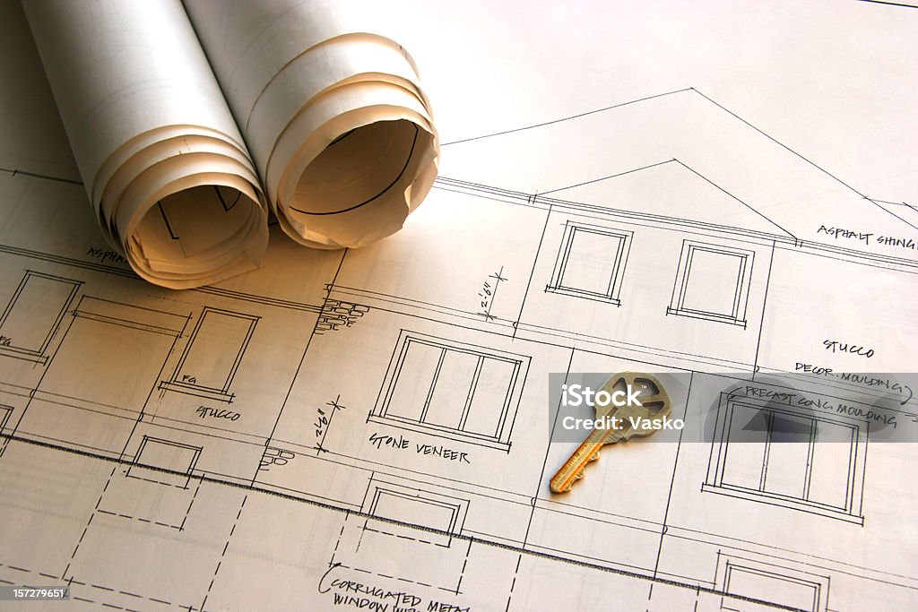 Home Improvements - Your house is ready!!! This is a picture of key and a set of blueprints resting on top of a set of architectural drawing.  The Key on the blueprint was left in such a way that a little PS and it could be removed without muddling with the rest of the image. Blueprint Stock Photo