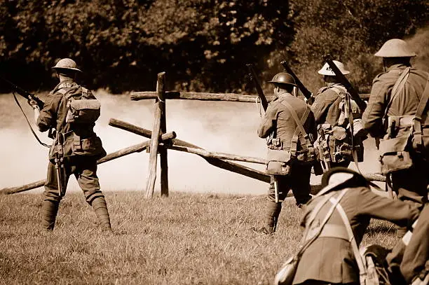 Re-enactors of the first world war (British troops)advance towards enemy troops