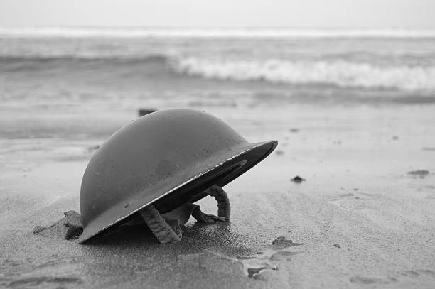Dunkirk Retreat. British Army Helmet left on the beach at Dunkirk after the retreat from the Germans 1940.re-enactment. meat packing industry photos stock pictures, royalty-free photos & images