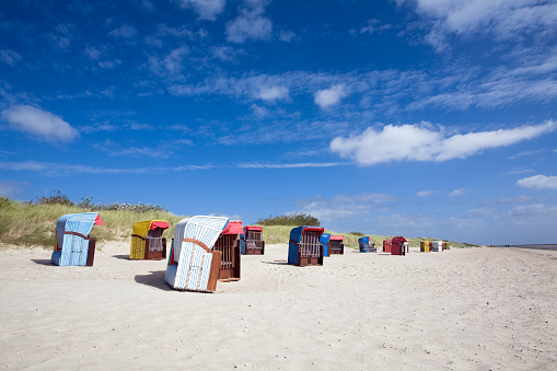 Colorful beach chairs on a beach at the North Sea