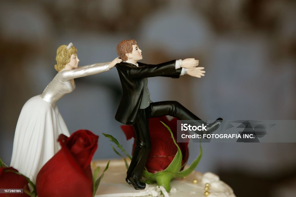 Wedding Cake Top Funny couple figurine on the wedding cake. Wedding Stock Photo