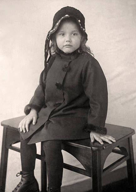 Little girl posing on small bench stock photo