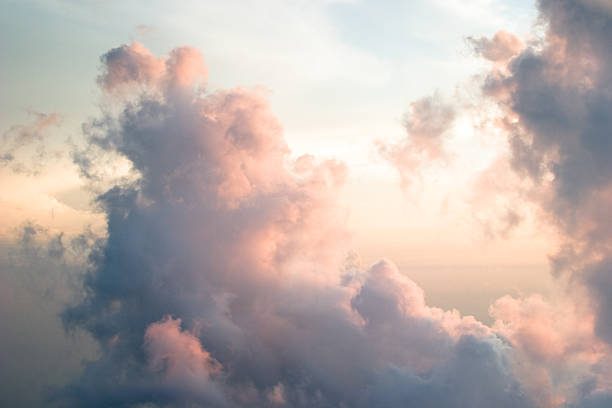 Sunset at 5000 feet The setting sun casts a warm glow on the clouds as we fly through them. 5000 feet stock pictures, royalty-free photos & images