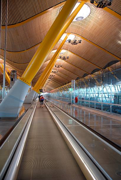 Madrid Airport Way cool airport. Ceiling is made up of bamboo slats. Need photos from Spain? Please see these...   airport travelator stock pictures, royalty-free photos & images
