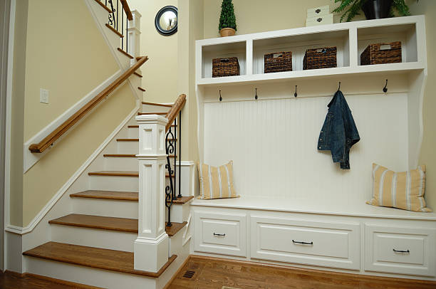 Mud Room Mud room with built-in coat rack and stairs to second floor. coat hook photos stock pictures, royalty-free photos & images
