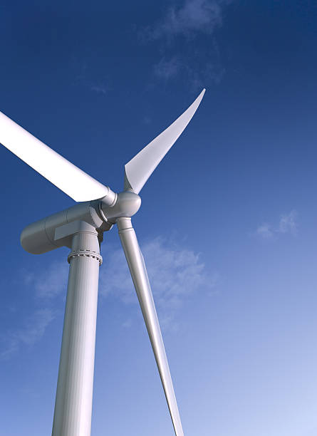 White wind energy windmill against a blue sky