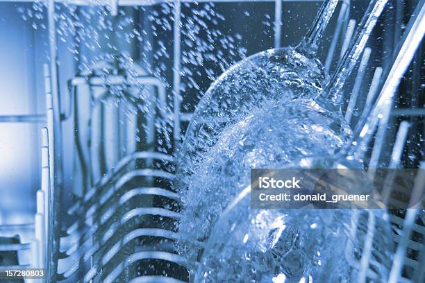 Interior Of Operating Dishwasher With Water Splashing On Wine Glasses Stock Photo - Download Image Now