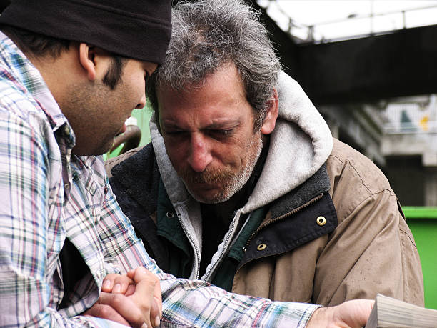 Homeless Male Crying with Listening to Scripture stock photo