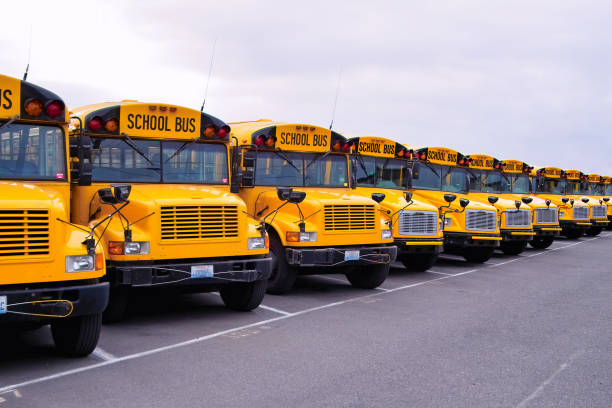 School Bus Lineup Seemingly endless row of yellow school buses. empty school bus stock pictures, royalty-free photos & images