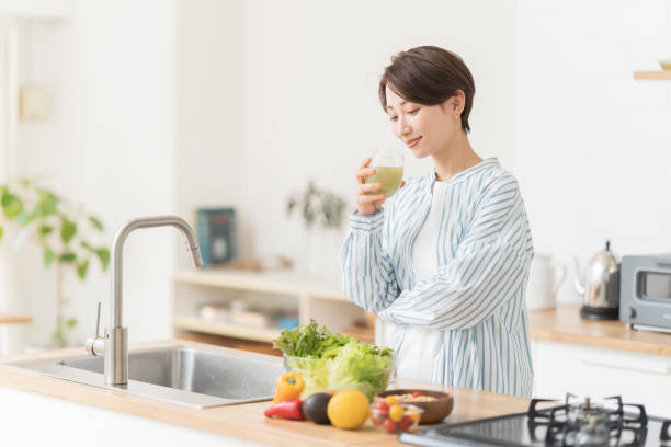istock Woman drinking fresh vegetable juice. 1572812013