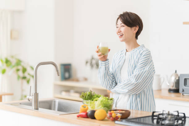 istock Woman drinking fresh vegetable juice. 1572812024