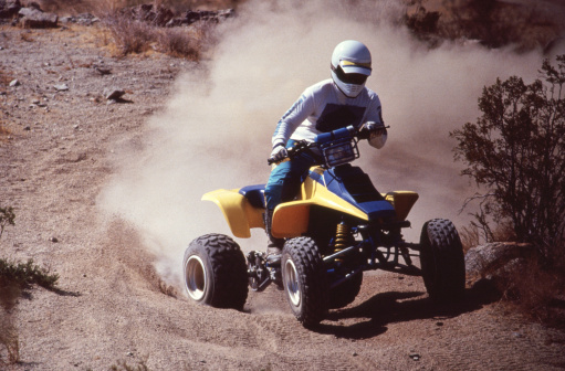 A four wheel ATV riding over the sand and rocks in the desert near Apple Valley, California.