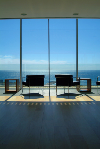Shot of the magnifical view, from a modern living-room, by the sea.