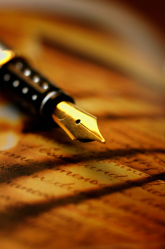 Stylish fountain pen and notebook on black wooden table, closeup