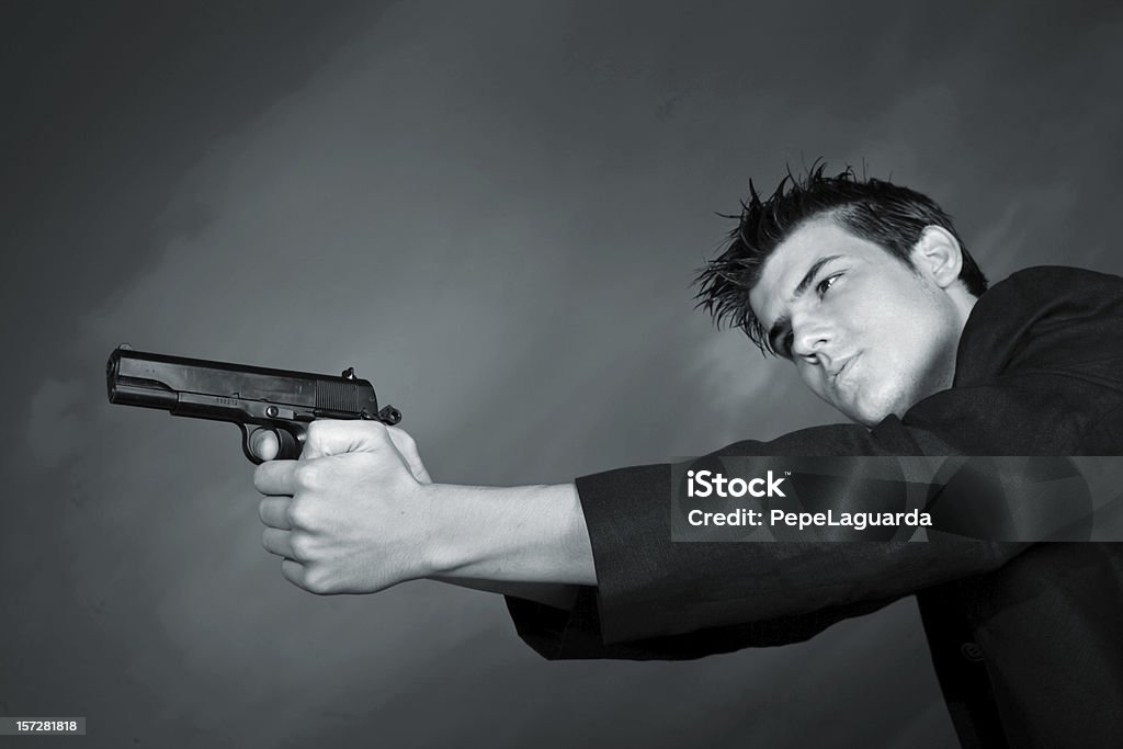 Policiac film A young man pointing with a gun Gun Stock Photo