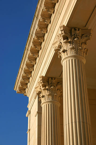 Golden Columns, Blue Sky Corinthian columns reflecting the golden light of an early sunset. support usa florida politics stock pictures, royalty-free photos & images