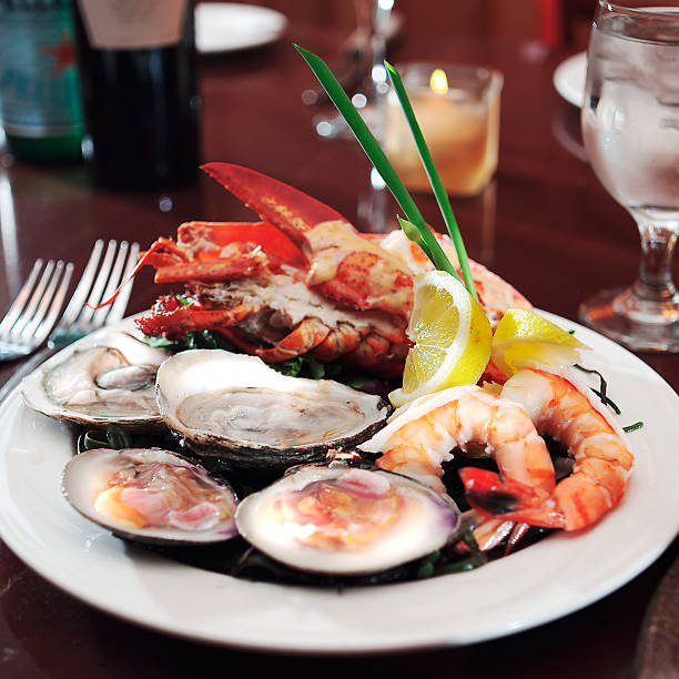 istock Plate of seafood on table with fork and glass 157281991