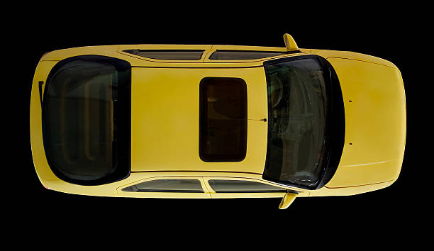 Arial view of yellow car isolated on black stock photo