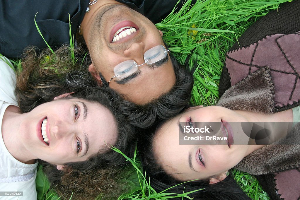 Best Friends 2 Best friends relaxing in the grass. Multiracial Group Stock Photo