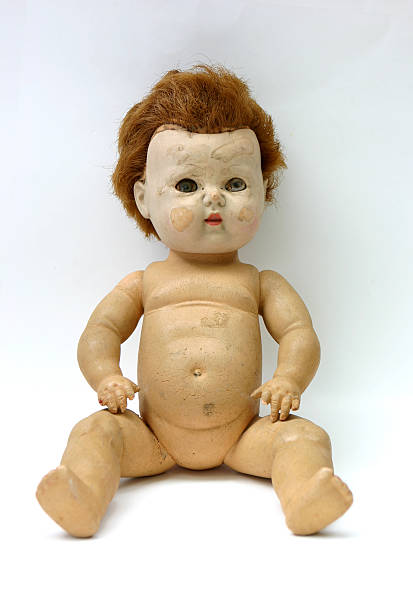 Face only a mother could love Old grungy spooky looking doll, porcelain face and rubber body that is worn with cracks from its old age. creepy doll stock pictures, royalty-free photos & images
