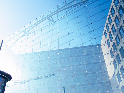 A modern office design building with transparent front windows...