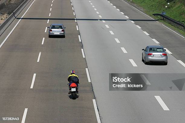 Cars And Motorcycle On A Quiet Fourlane Highway Stock Photo - Download Image Now - Motorcycle, Car, Rear View