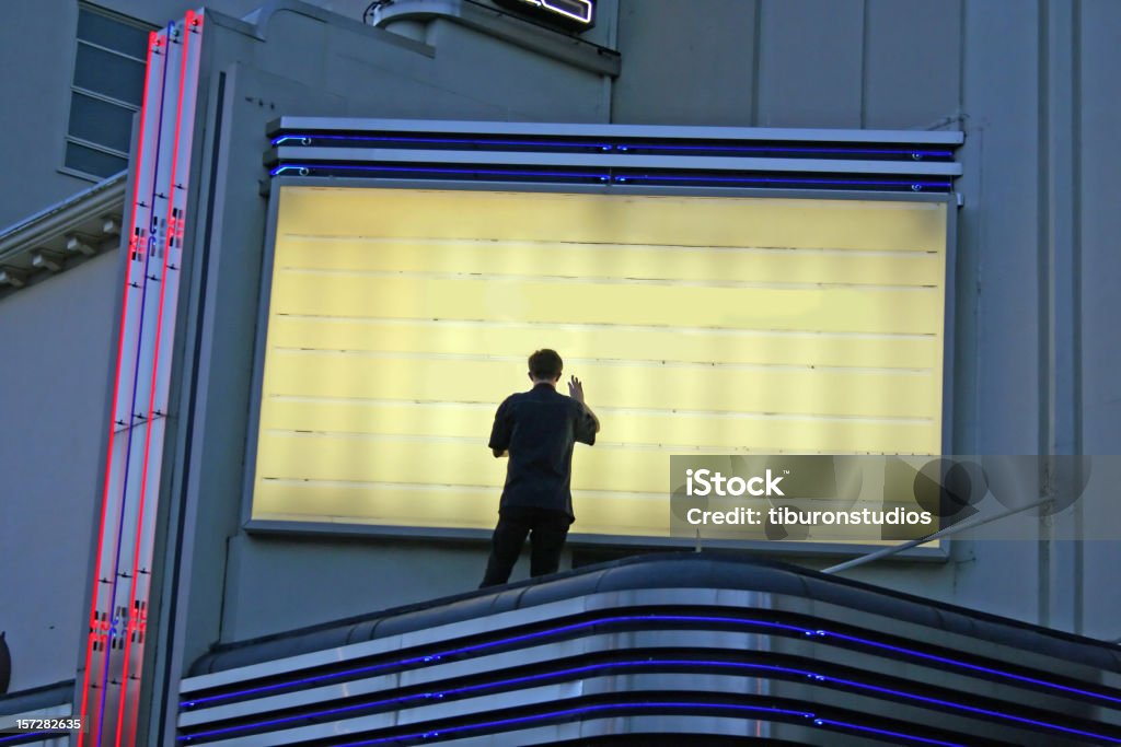 Now Showing! Man Changing Sign Changing Movie Currently Playing - Great for any communication of a change with room to put your text Theater Marquee Stock Photo