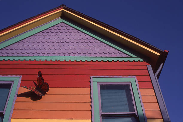 Colorful House detail of an historic house painted in many bright colors, deep blue sky background. Scan of 35mm transparency. pacific grove stock pictures, royalty-free photos & images