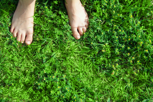Kid's feet on the grass...feeling the texture of the nature!