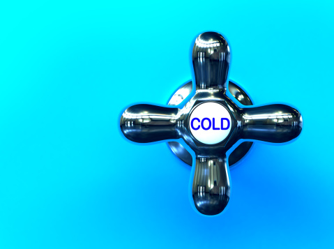 A cold water faucet on a blue background.  3D rendering with hdri lighting and raytraced textures.