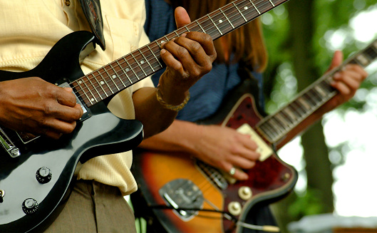 Close up shot of two guitar players shot at the Chicago Bluesfestival. Only shows guitars and hands.