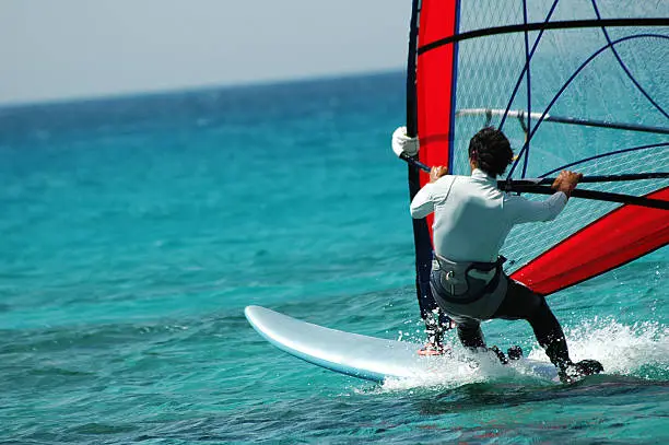 a red wind surfer