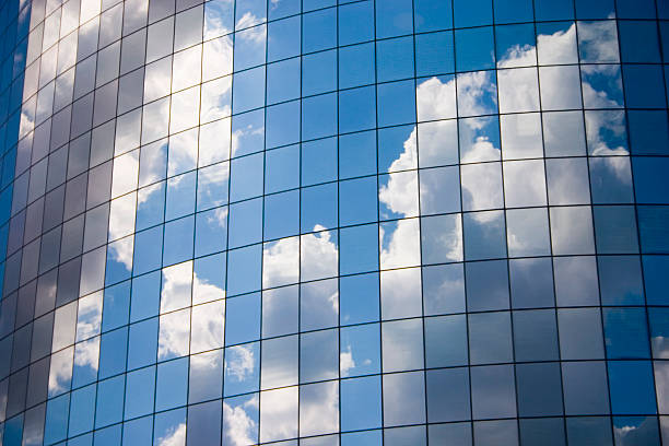 Futuristic abstract business background with reflected blue skies and clouds stock photo