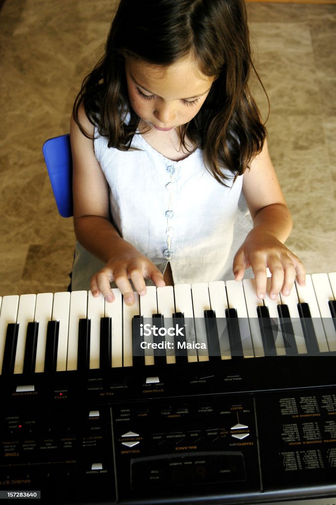 Enjoying the music An 8 years old playing piano. 8-9 Years Stock Photo