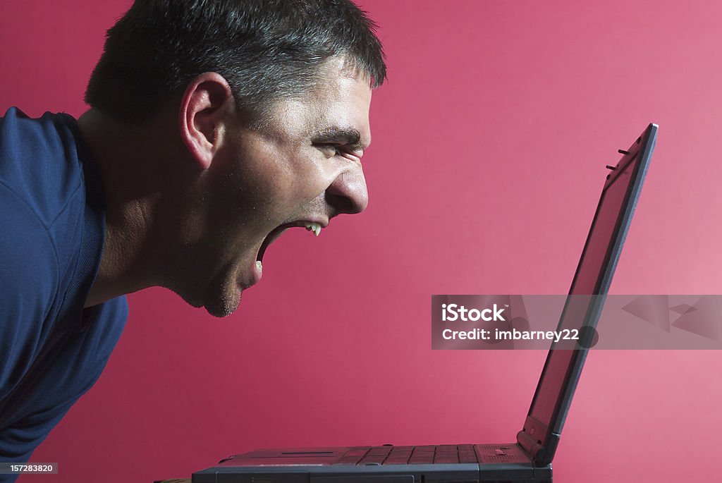 Bad day at the office Man screaming at his laptop Internet Stock Photo