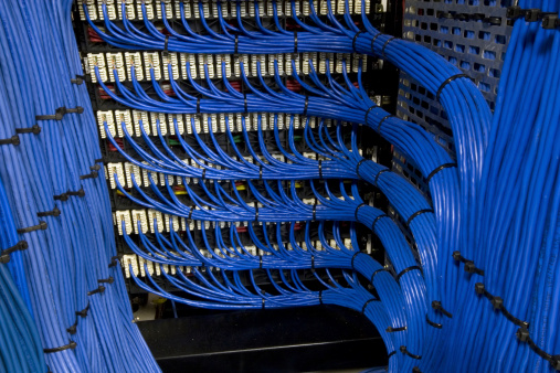 Blue network cables neatly channelled into their specified ports.