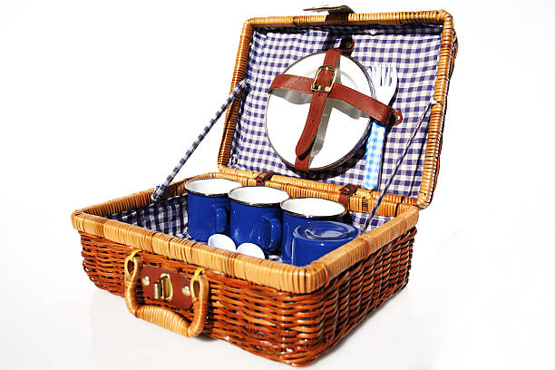 A picnic basket made of wicker and blue dishes stock photo
