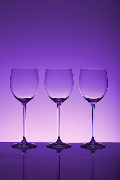 Stemware Three crystal wine glasses with dramatic lighting & room for copy. triumvirate stock pictures, royalty-free photos & images