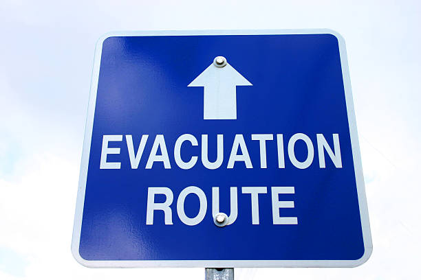 istock Blue and white sign with evacuation route on and arrow 157284029