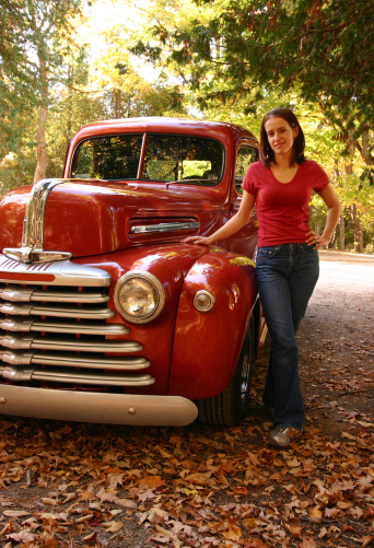 Young lady with a cute old car