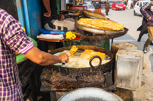 Khaniyar, Srinagar, Jammu and Kashmir, India. Frying food at a market in Srinagar.