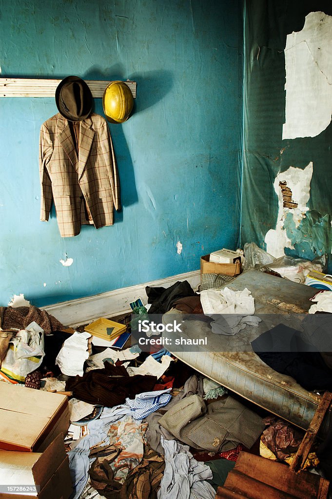 Grunge Bedroom Interior view of an abandoned home.  Clothes & belongings strewn throughout. Abandoned Stock Photo