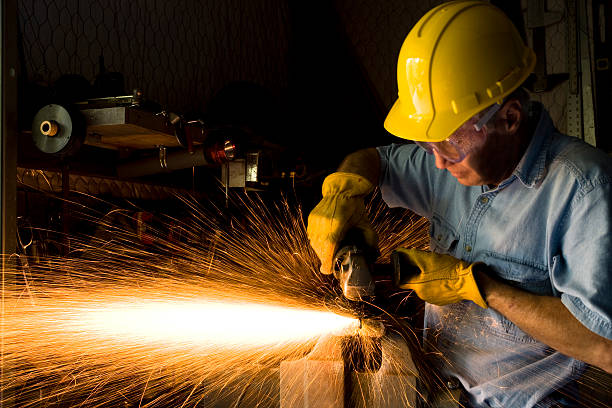 istock Industry: Man Grinding in workshop wearing hardhat and gloves.  Sparks 157286251
