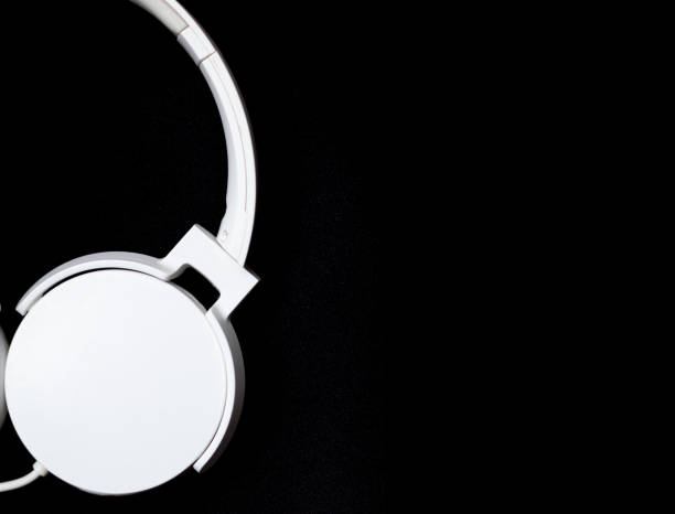 istock White headset isolated on a black background. Image with copy space. Music and podcast concept. 1572866321