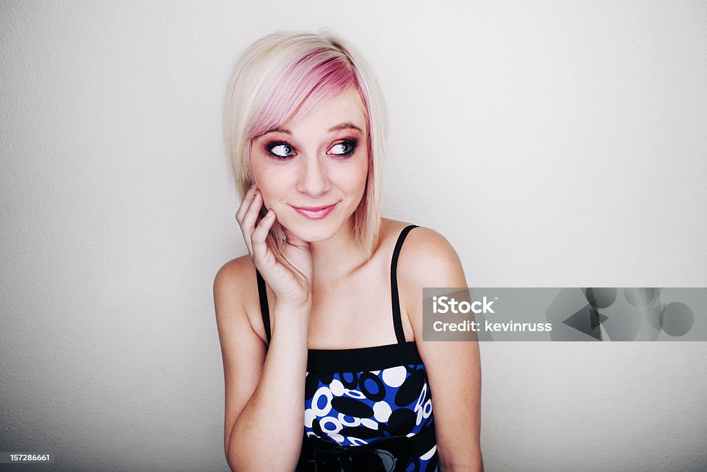 Blonde Girl with Blue and Black Dress on White Wall  18-19 Years Stock Photo