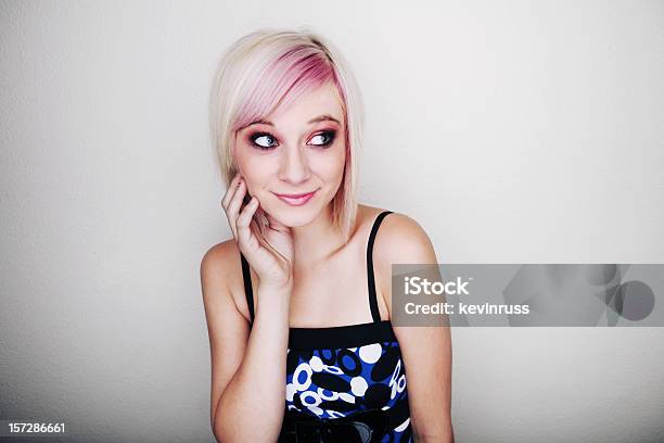 Blonde Girl With Blue And Black Dress On White Wall Stock Photo - Download Image Now