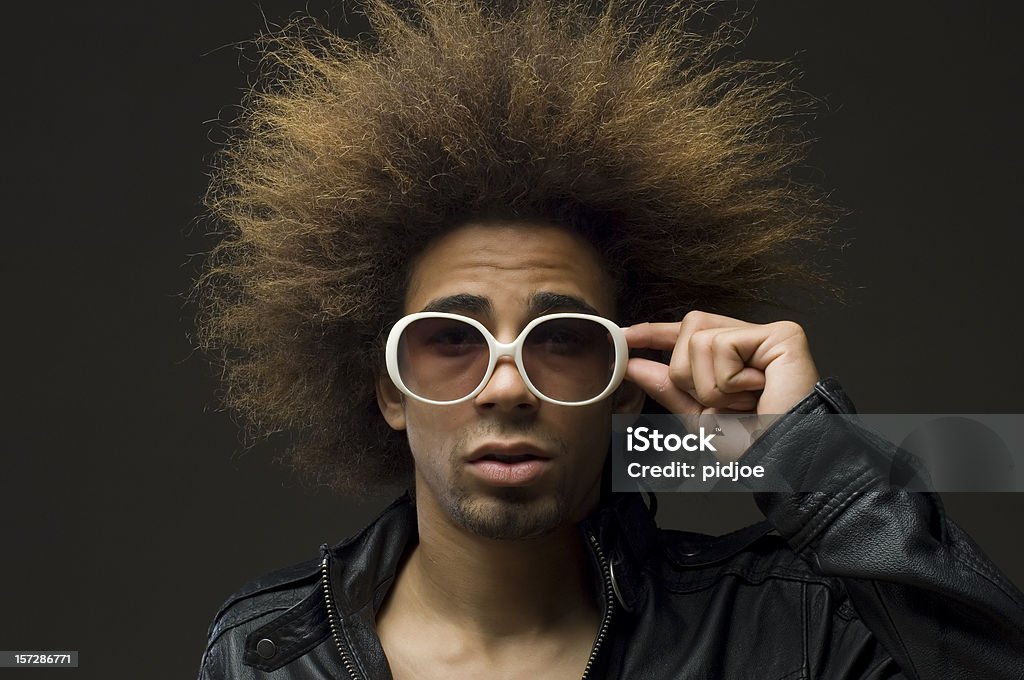 are you looking at me close up of cool funky man with big hair touching his white sunglasses looking self confident Men Stock Photo