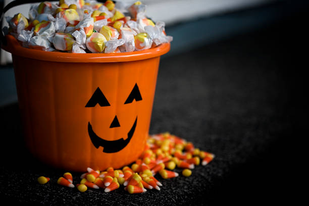 Bucket of Halloween Candy with Jack o Lantern, Copy Space  halloween treats stock pictures, royalty-free photos & images